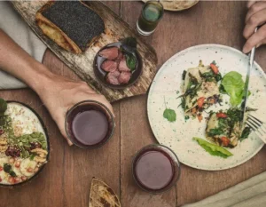 A table set with various dishes and glasses of wine, ready for a delicious meal.
