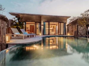 Stunning house with beautiful swimming pool and poolside chairs.