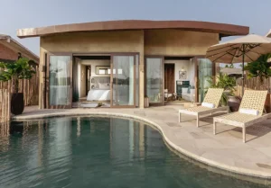 Stunning house with beautiful swimming pool and poolside chairs.