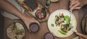 A table set with various dishes and glasses of wine, ready for a delicious meal.