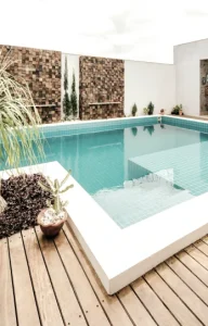 A wooden deck overlooking a lush garden.